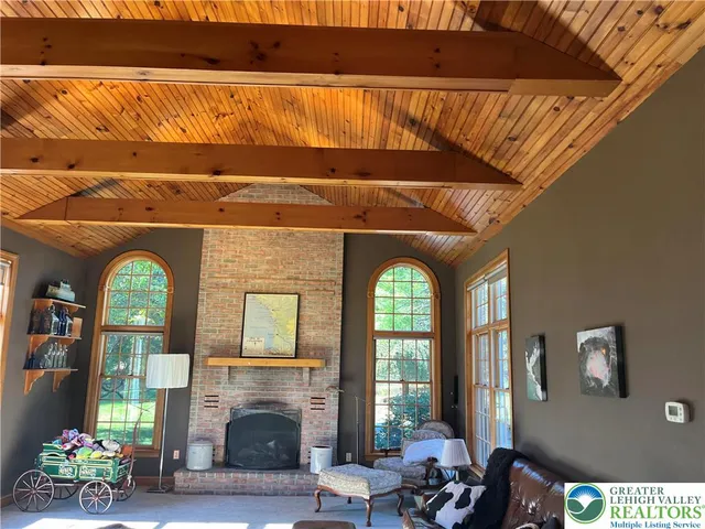a living room with a couch bookshelf and a flat screen tv