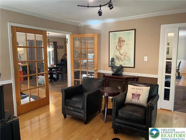 a bedroom with a bed and a flat tv screen on dresser