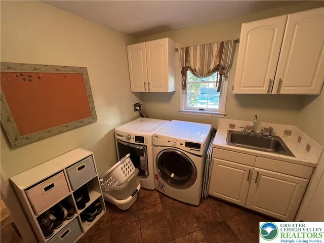 a view of walk in closet with clothes