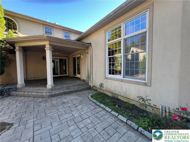 a view of a house with backyard and sitting area