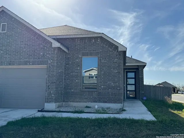 a brick building with garden in front of it