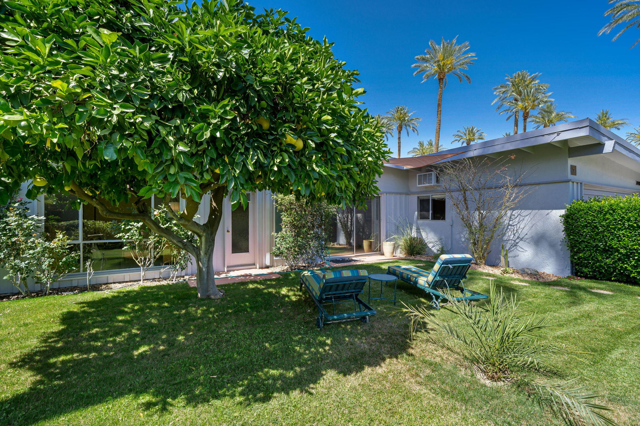 70418 Tamarisk Lane Rancho Mirage, CA 92270 - Photo 18 of 41 a front view of a house with garden