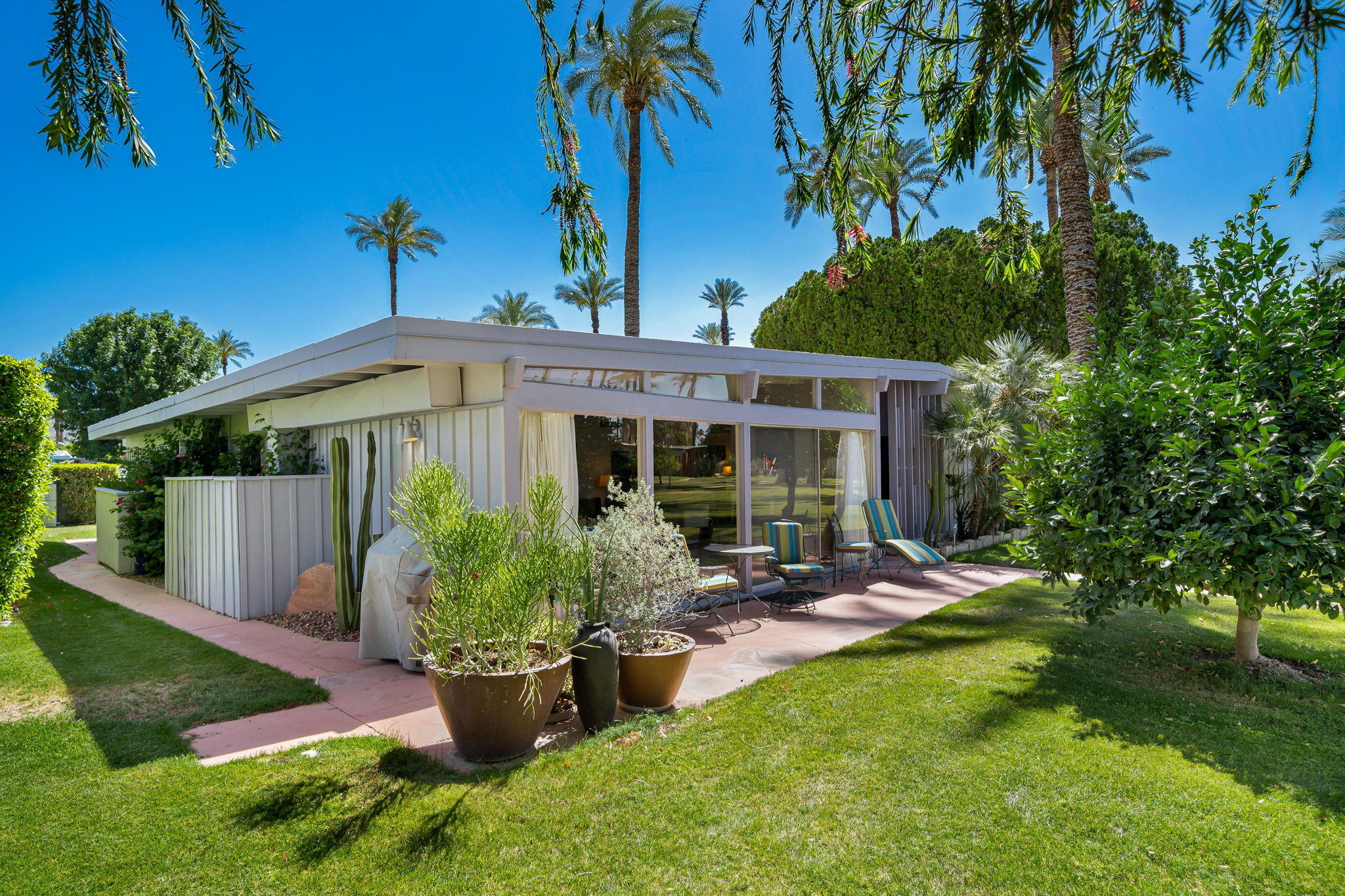 70418 Tamarisk Lane Rancho Mirage, CA 92270 - Photo 19 of 41 a view of a house with backyard sitting area and garden