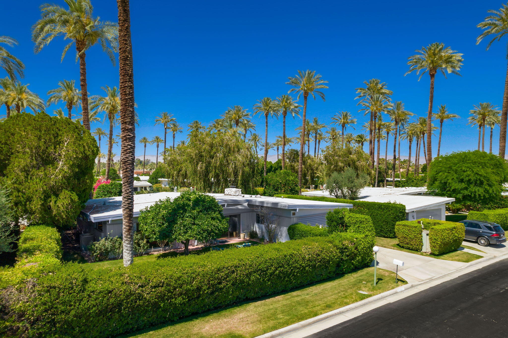 70418 Tamarisk Lane Rancho Mirage, CA 92270 - Photo 4 of 41 a view of a garden with a building in the background