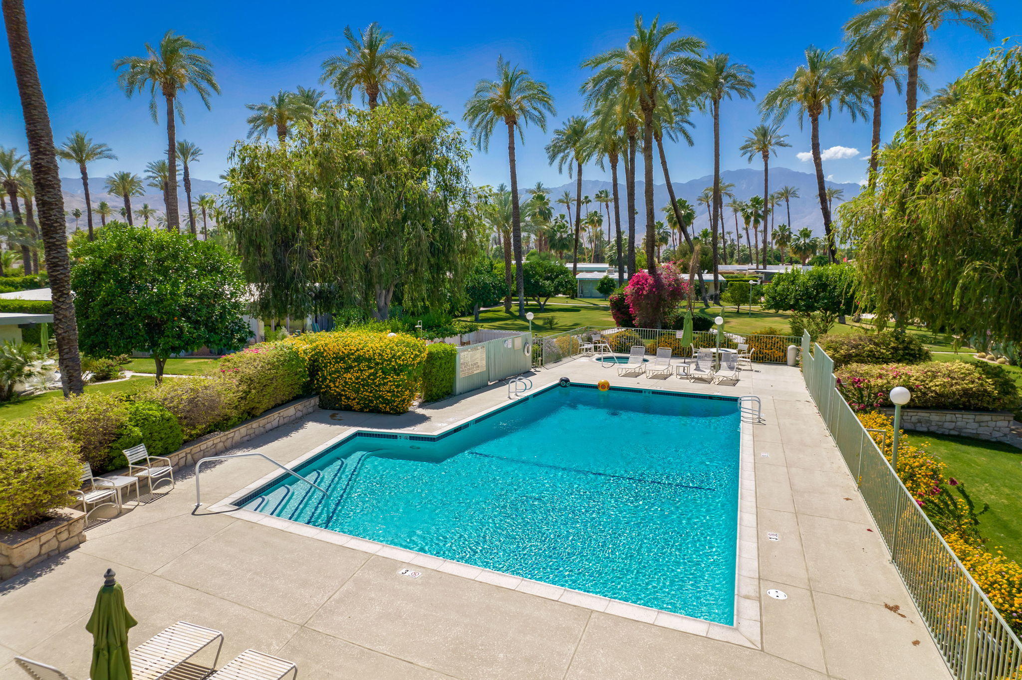 70418 Tamarisk Lane Rancho Mirage, CA 92270 - Photo 10 of 41 a view of a swimming pool with a patio and a garden