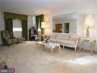 867 Kent Lane Philadelphia, PA 19115 - Photo 3 of 6 a living room with furniture and a large mirror next to a window