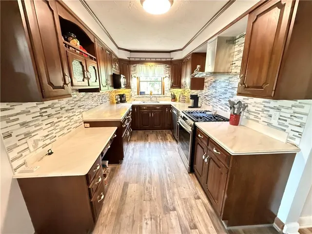 a kitchen with stainless steel appliances granite countertop a sink and cabinets