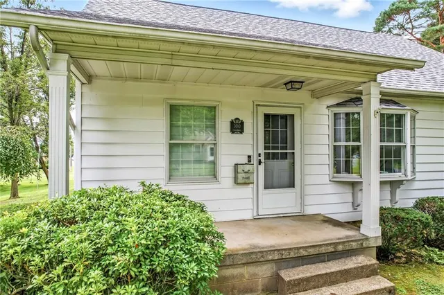 a front view of a house with a garden