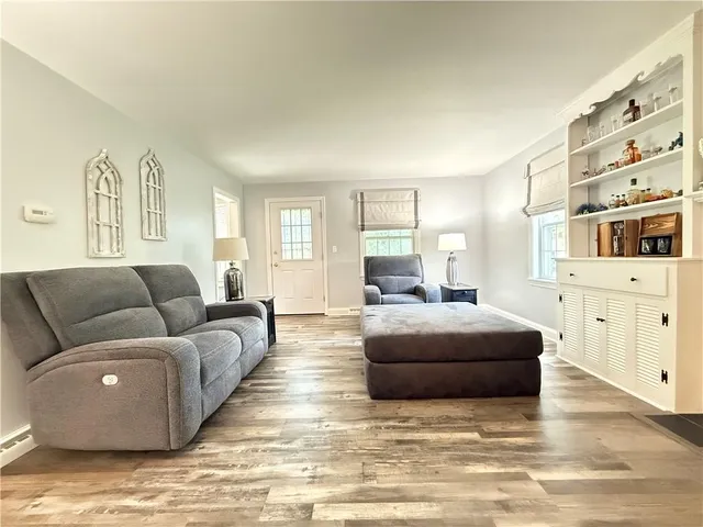 a living room with a fireplace and a book shelf
