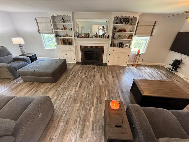 a view of a living room with furniture and a fireplace
