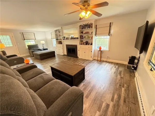 a bedroom with furniture window and flat screen tv