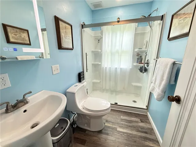 a living room with furniture a rug and wooden floor