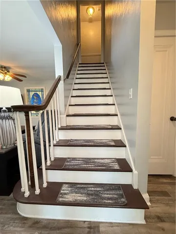 a view of a bedroom with wooden floor and furniture