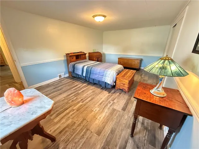 a bed sitting in a bedroom next to a window