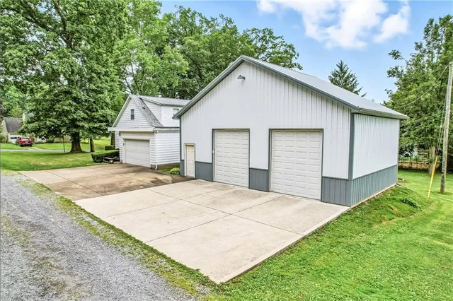 a view of a house with a yard and garage