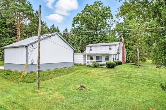 a view of a house with a yard and sitting area