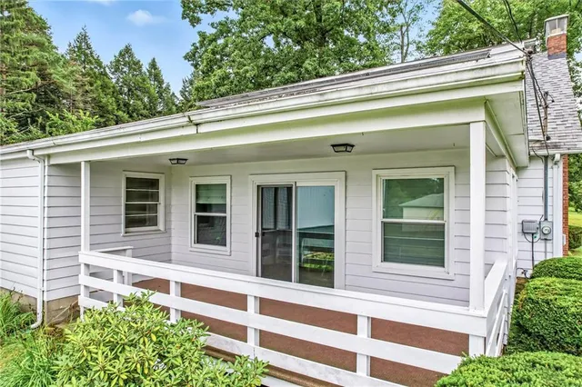 a view of a house with a window and sitting area