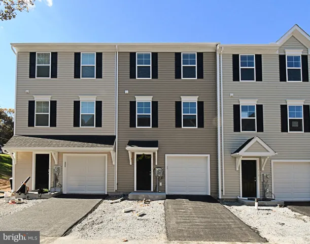 a view of a hallway with wooden floor and entryway