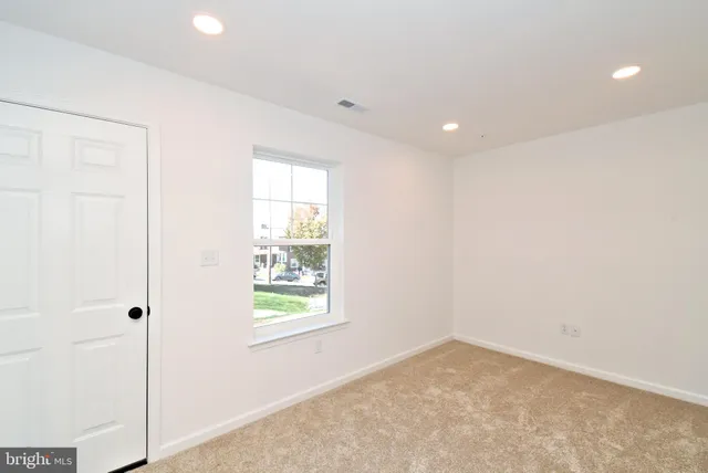 a kitchen with stainless steel appliances granite countertop a sink a stove a refrigerator and island with wooden floor