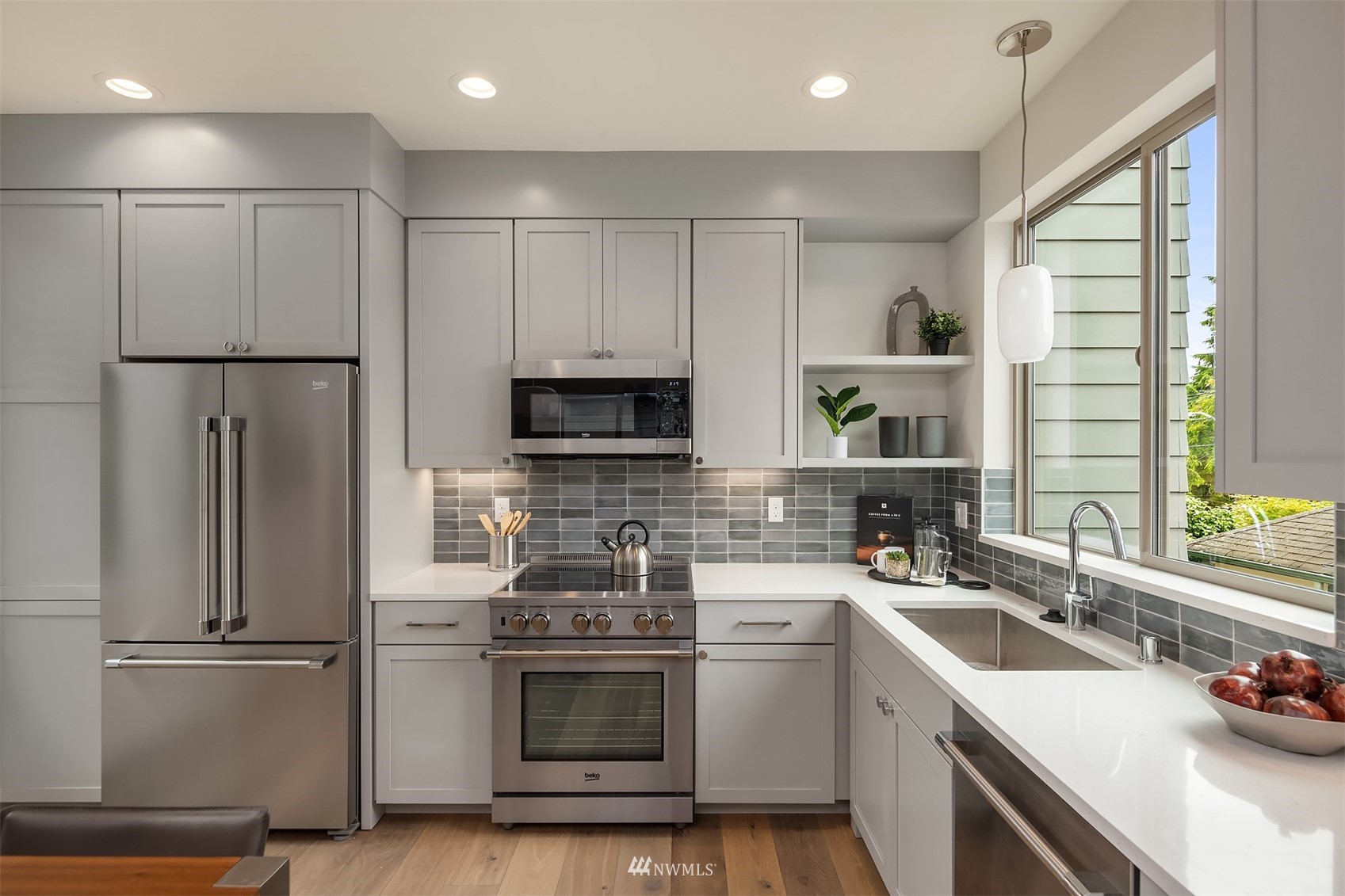 750 North 68th Street, Unit B Seattle, WA 98103 - Photo 11 of 19 a kitchen with stainless steel appliances a sink cabinets and a refrigerator