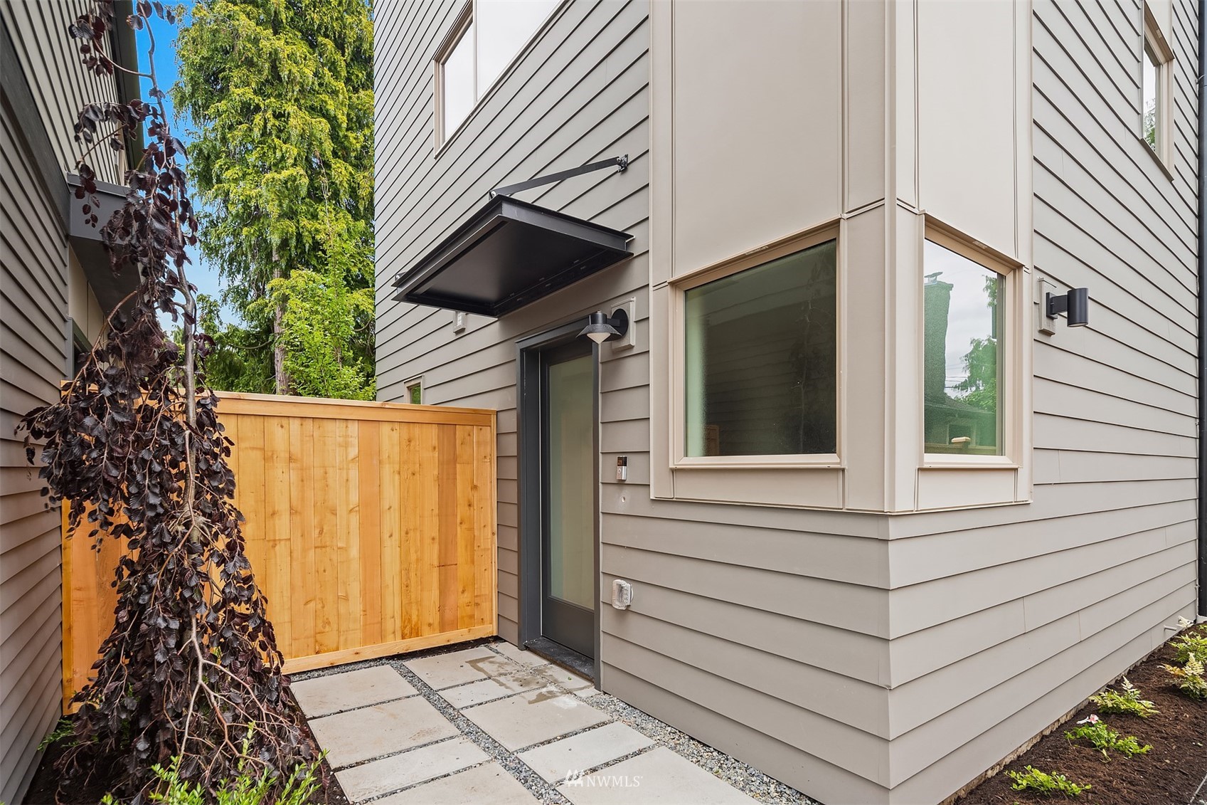 750 North 68th Street, Unit B Seattle, WA 98103 - Photo 2 of 19 a view of entryway with a window and wooden fence