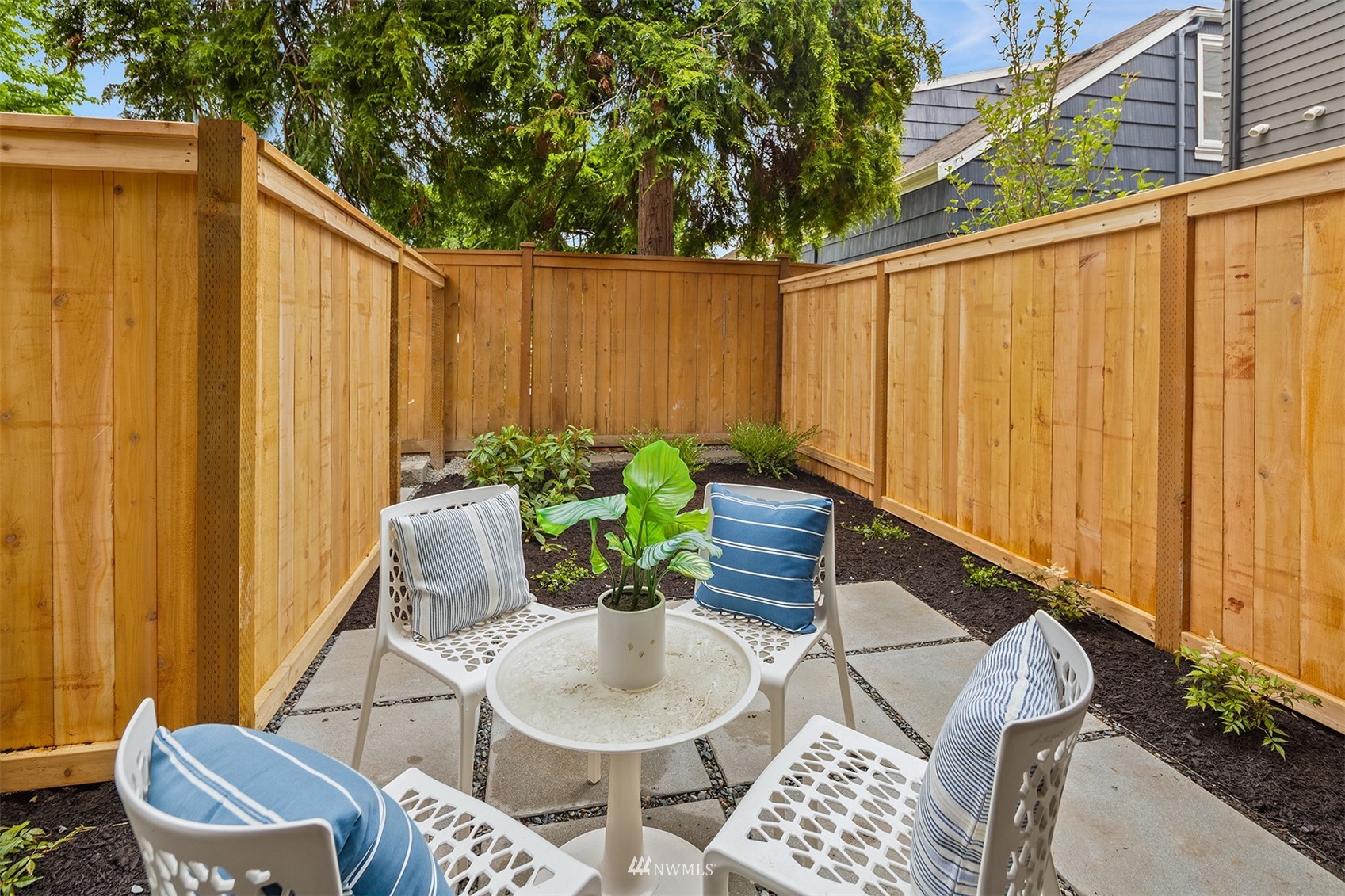 750 North 68th Street, Unit B Seattle, WA 98103 - Photo 3 of 19 a backyard of a house with table and chairs