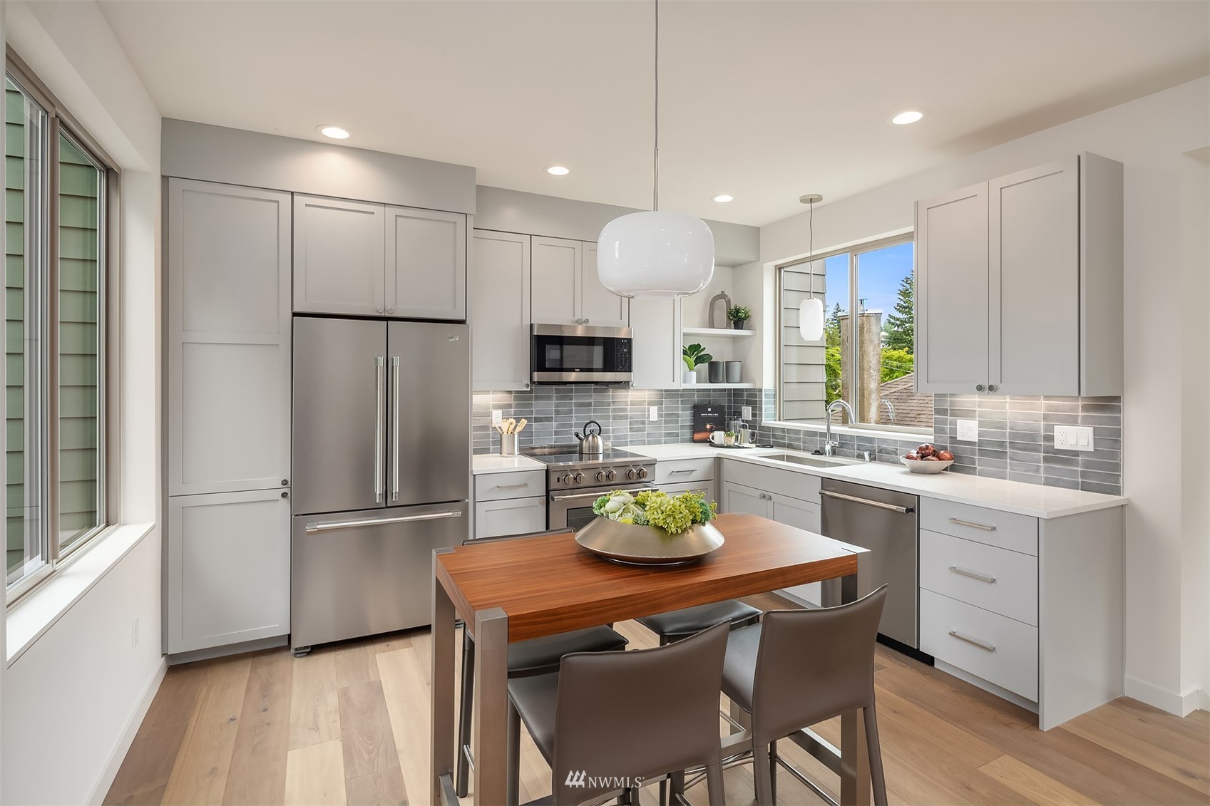 750 North 68th Street, Unit B Seattle, WA 98103 - Photo 10 of 19 a kitchen with a refrigerator a dining table and chairs