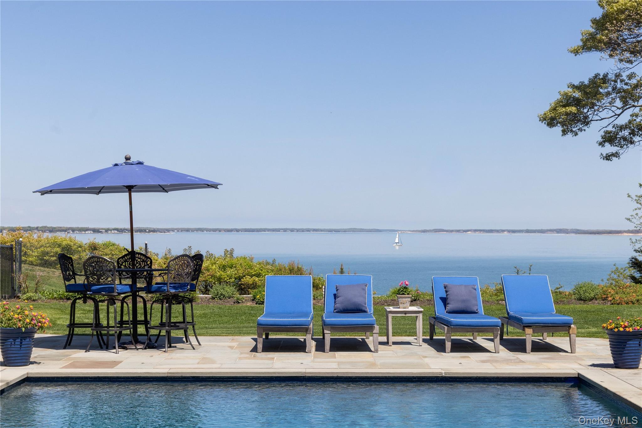 3745 Nassau Point Road Cutchogue, NY 11935 - Photo 7 of 36 Outdoor pool with a patio and a water view