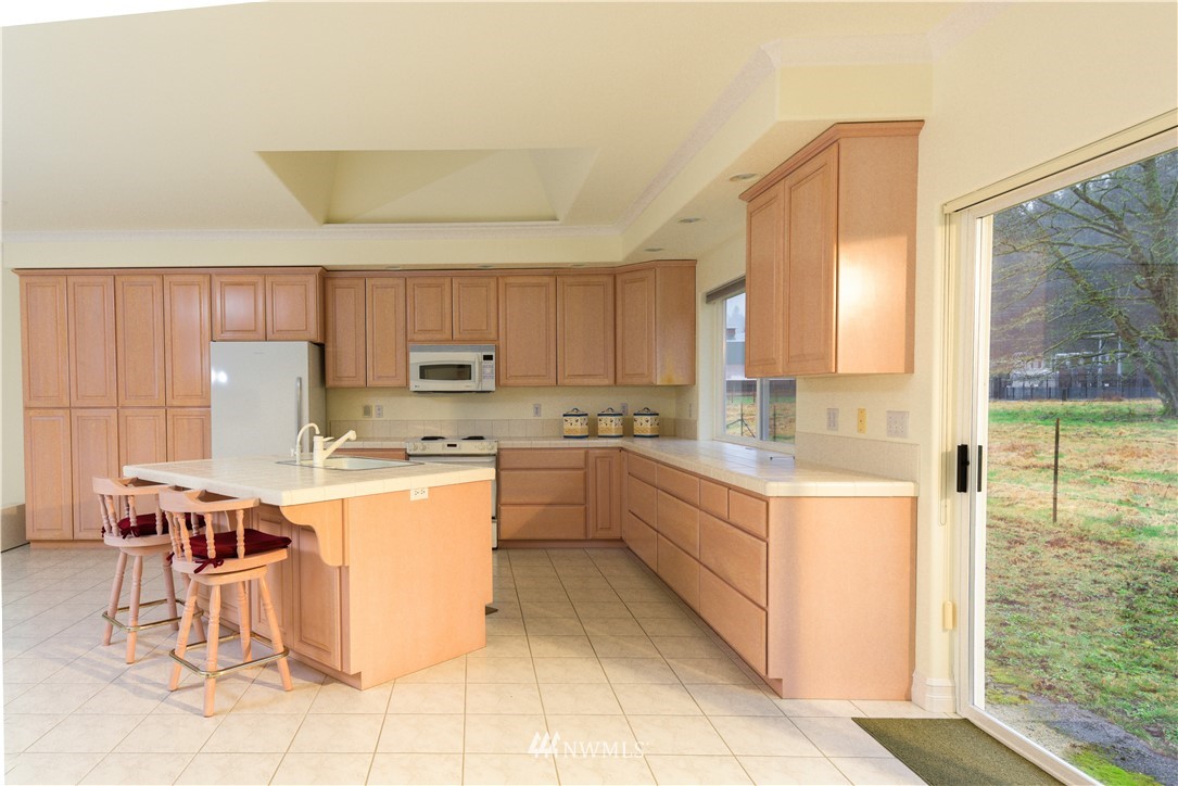 23020 Oso Loop Road Arlington, WA 98223 - Photo 3 of 19 a kitchen with a sink a counter top space and appliances