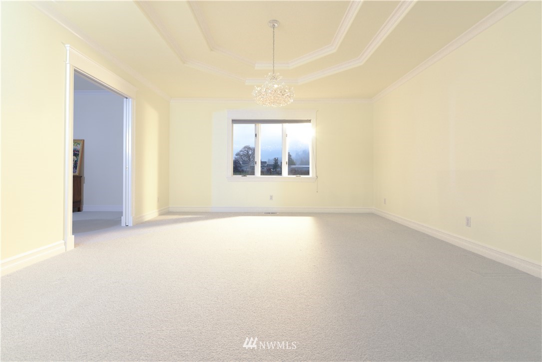 23020 Oso Loop Road Arlington, WA 98223 - Photo 5 of 19 an empty room with a window and wooden floor