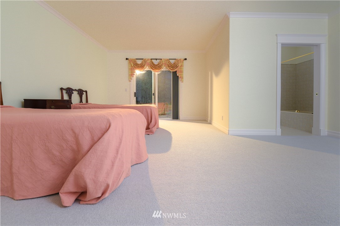 23020 Oso Loop Road Arlington, WA 98223 - Photo 8 of 19 a bedroom with a bed and a mirror