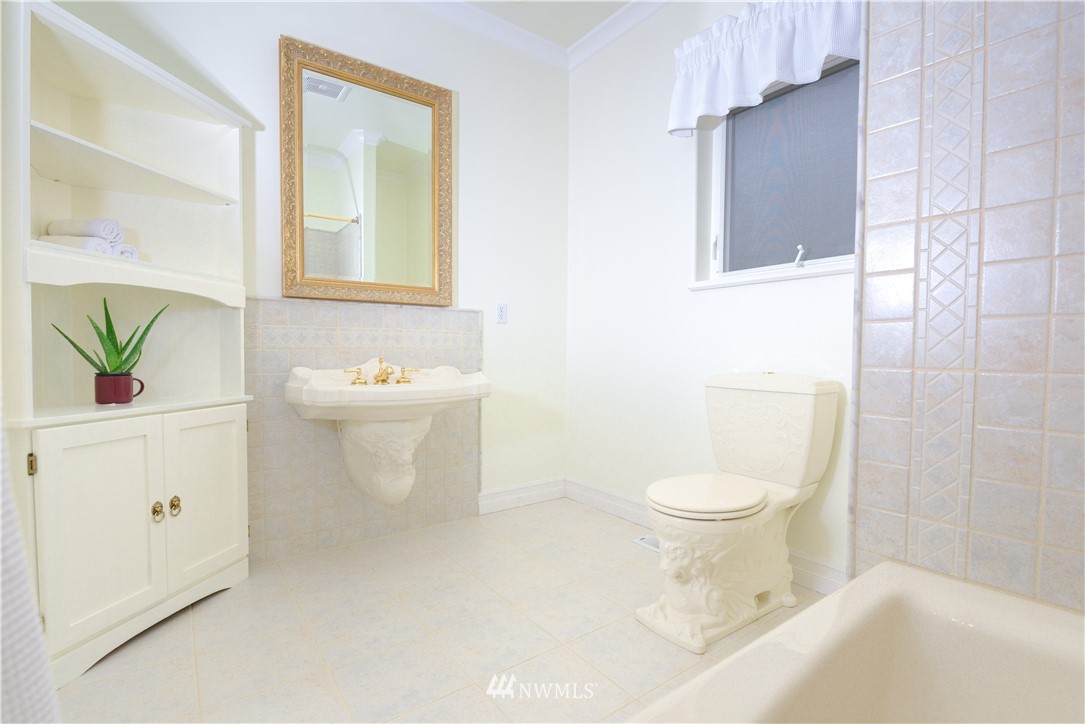 23020 Oso Loop Road Arlington, WA 98223 - Photo 9 of 19 a white toilet sitting next to a bathroom sink