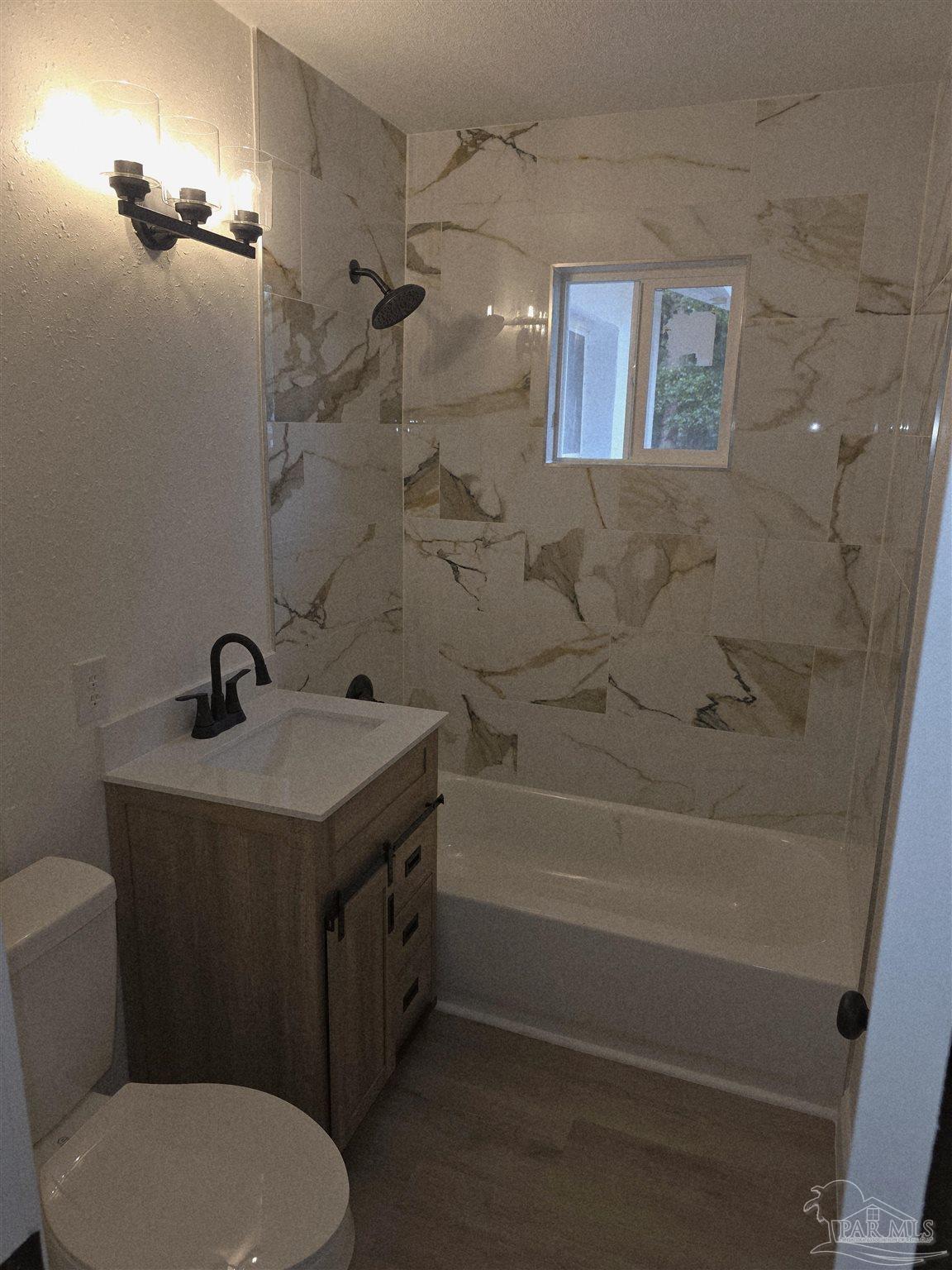 302 Dixie Street Crestview, FL 32536 - Photo 17 of 17 a bathroom with a sink a toilet and shower