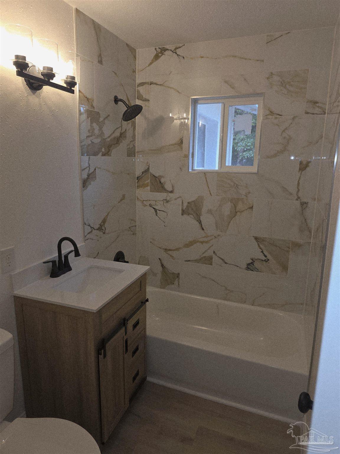 302 Dixie Street Crestview, FL 32536 - Photo 7 of 17 a bathroom with a granite countertop sink toilet and shower