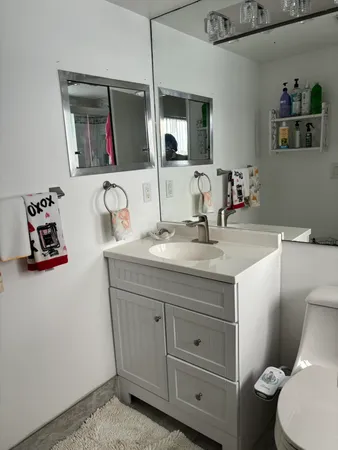 a bathroom with a toilet sink and mirror