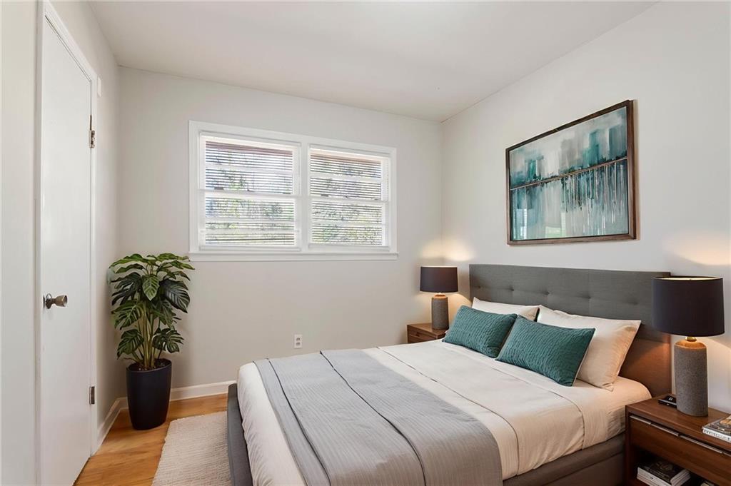 419 East 13th Street Rome, GA 30161 - Photo 13 of 27 a bedroom with a large bed and a potted plant