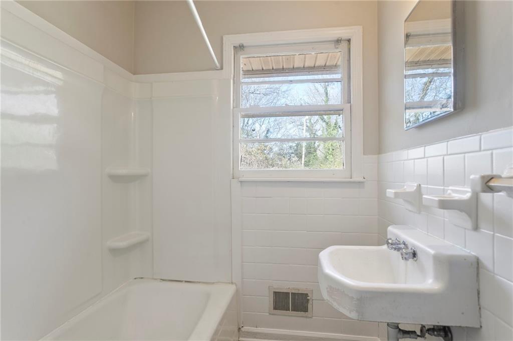 419 East 13th Street Rome, GA 30161 - Photo 14 of 27 a bathroom with a sink a toilet and shower