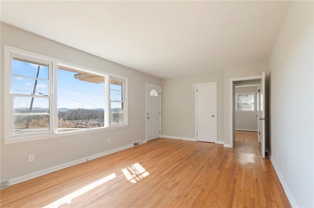 419 East 13th Street Rome, GA 30161 - Photo 5 of 27 a view of an empty room with wooden floor and a window