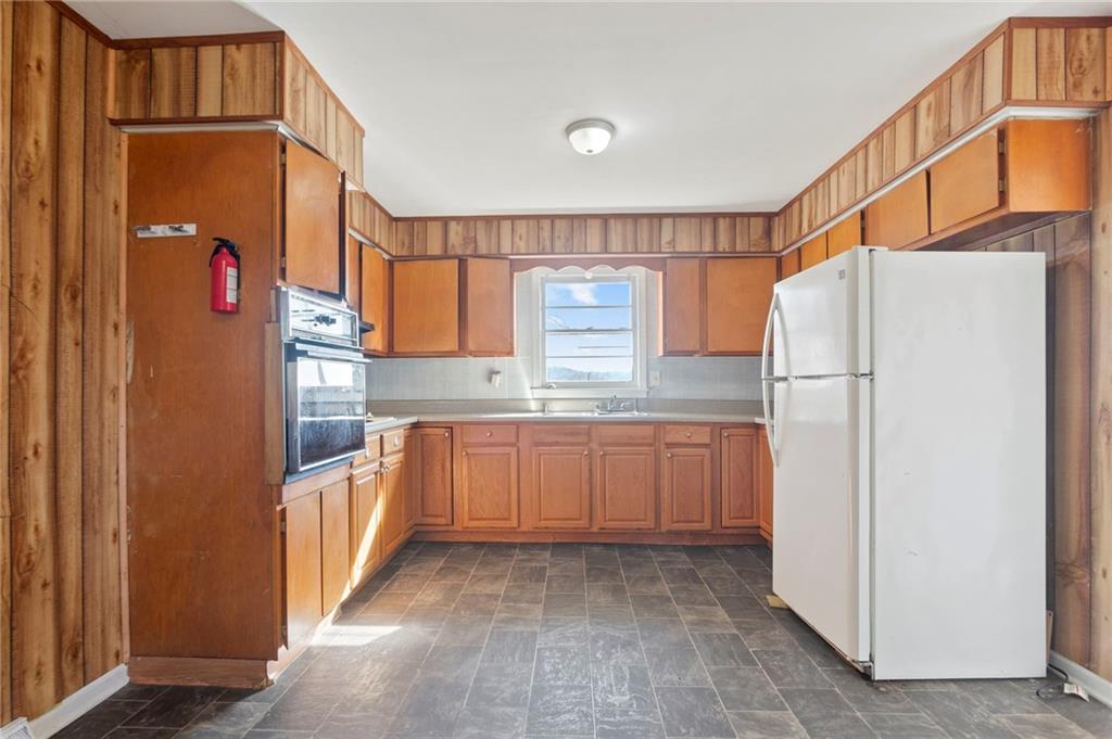 419 East 13th Street Rome, GA 30161 - Photo 10 of 27 a kitchen with granite countertop a refrigerator and a sink