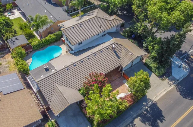 a view of a house with a yard and a garden