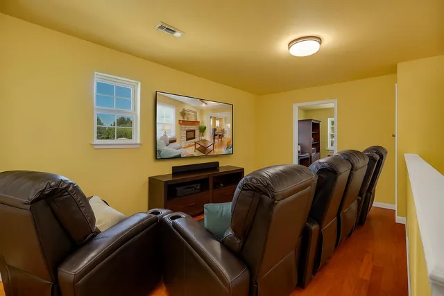 a living room with furniture and a piano