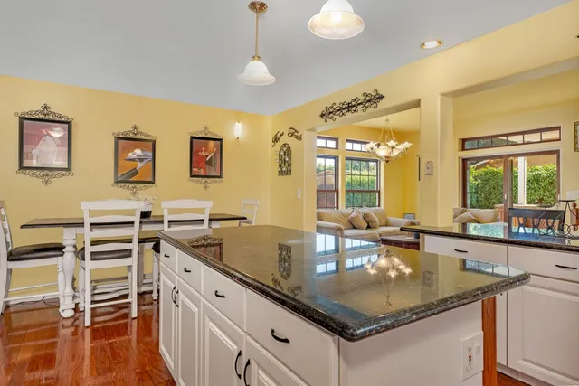 a kitchen with stainless steel appliances granite countertop a sink and a counter space