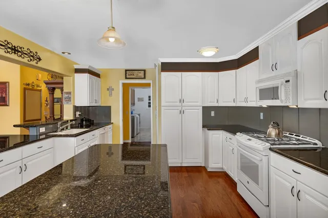 a kitchen with a sink stove and refrigerator