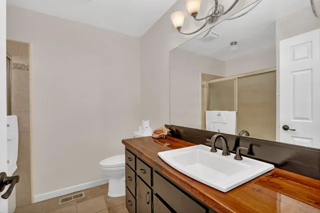 a bathroom with a sink a toilet and mirror