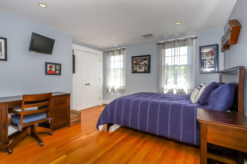 6 Colonial Lane Canton, MA 02021 - Photo 23 of 42 a bedroom with a bed and wooden floor