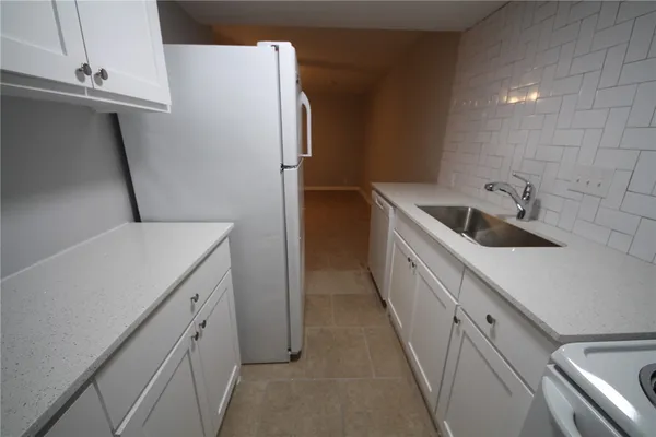 a kitchen with a sink and refrigerator