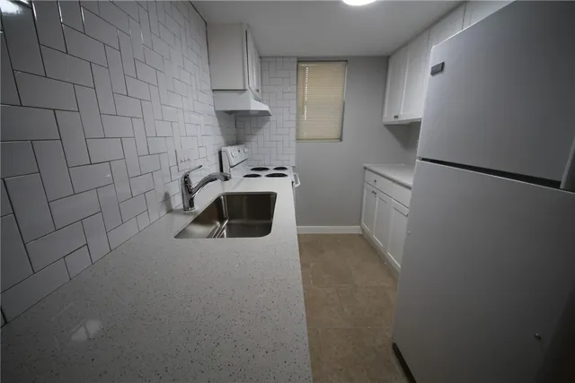 a kitchen with a refrigerator sink and stove