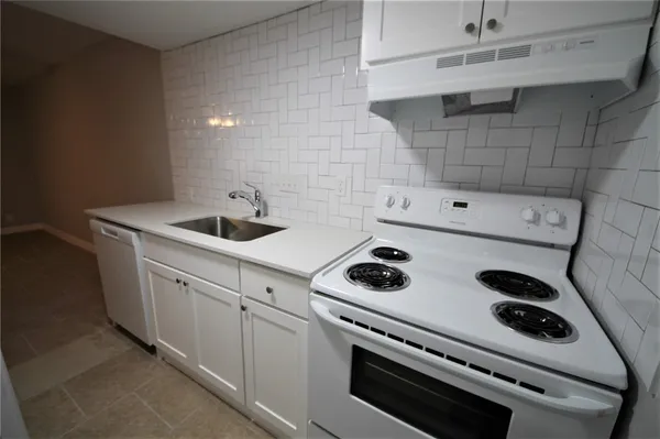 a kitchen with a stove and a sink
