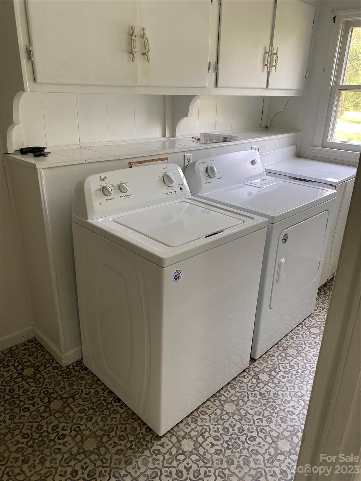 17183 Pond Road Locust, NC 28097 - Photo 11 of 14 a utility room with cabinets washer and dryer