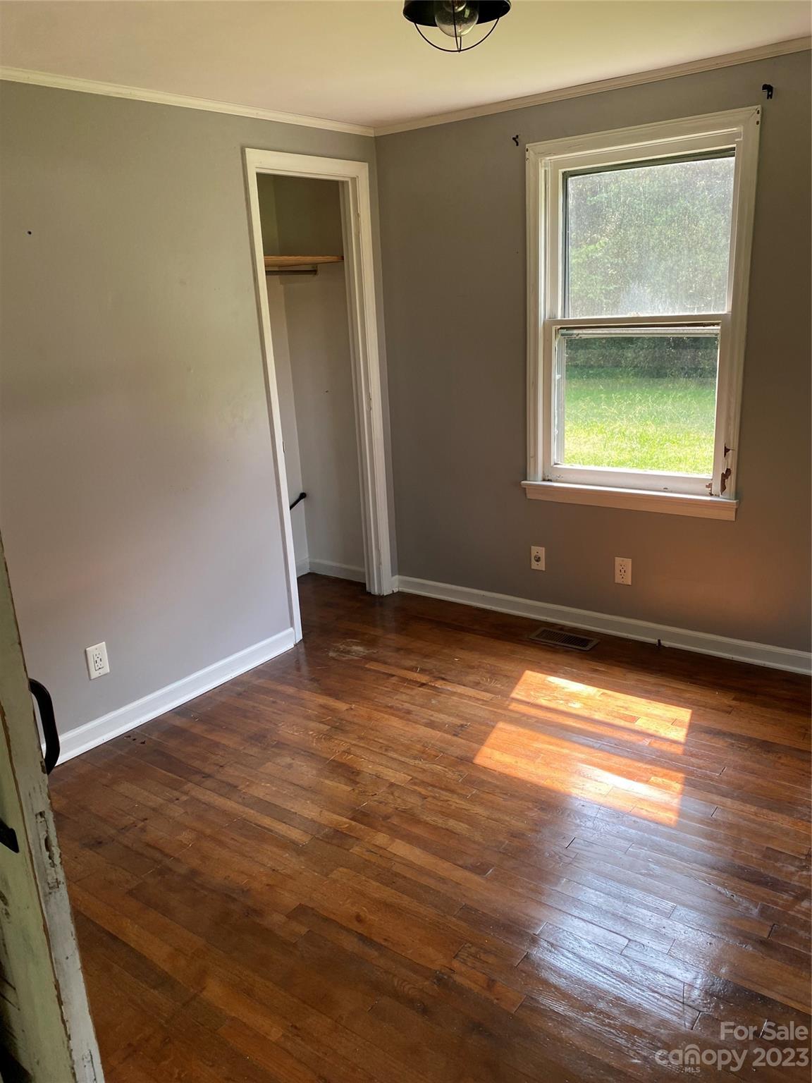 17183 Pond Road Locust, NC 28097 - Photo 2 of 14 a view of empty room with window and wooden floor